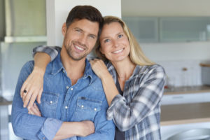 Portrait of cheerful middle-aged couple at home