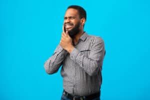 A man with a toothache that could be treated with a laser root canal in Melville