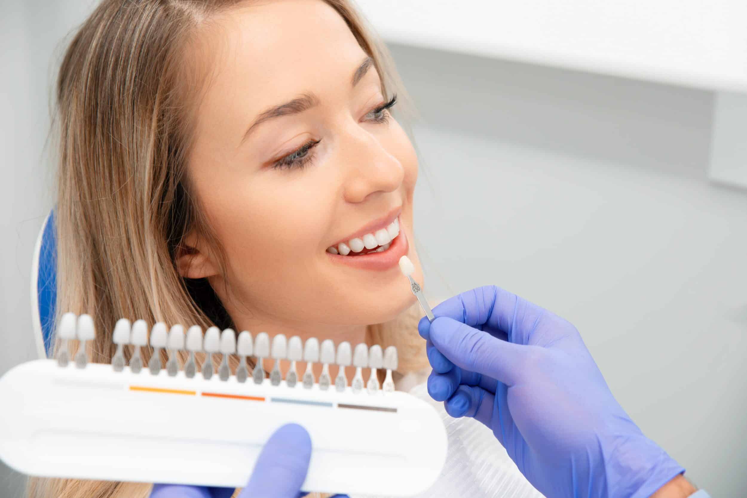 A woman choosing a shade for her veneers