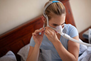 shutterstock 1537947122 woman with cpap preparing for bed