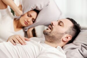shutterstock 2102981113 woman can't sleep because of snoring husband